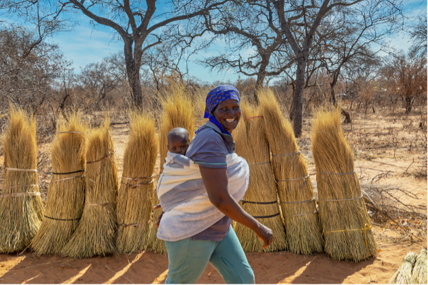 Smiling woman carrying her child